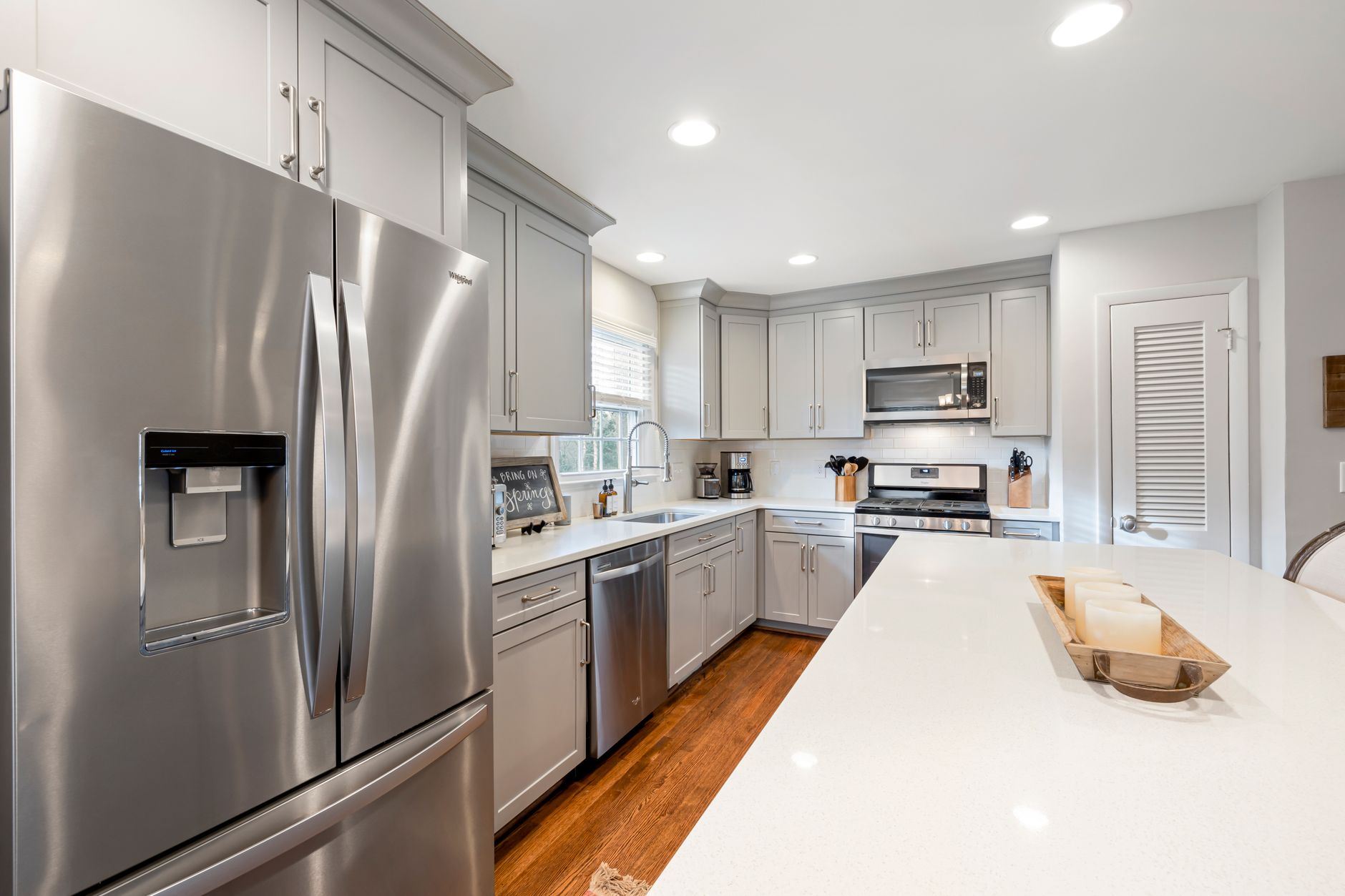 Bright modern kitchen featuring stainless steel appliances and white countertops in Riverside, CA