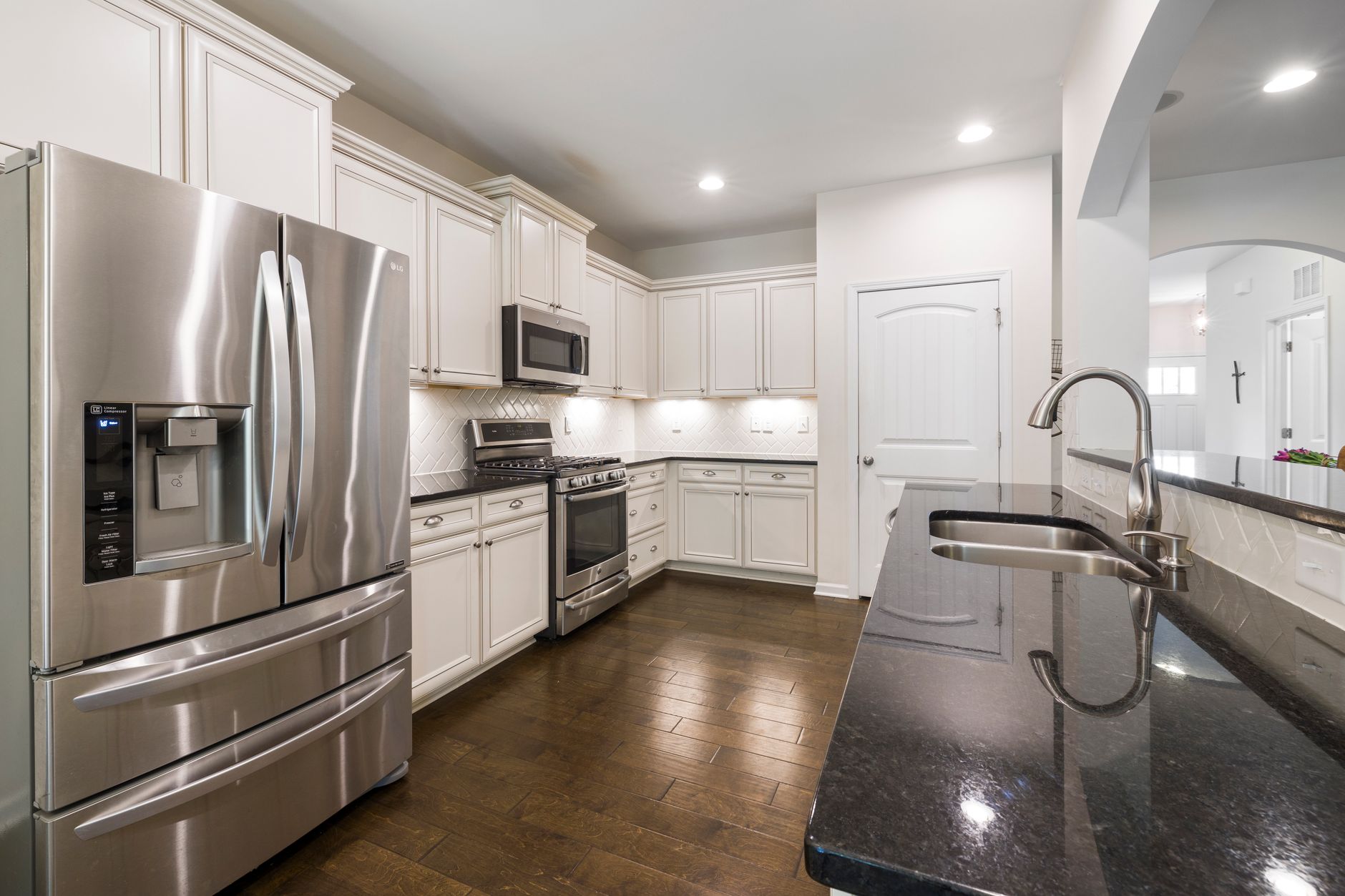 Bright modern kitchen with stainless steel appliances, granite countertops, and wooden flooring in Riverside, CA